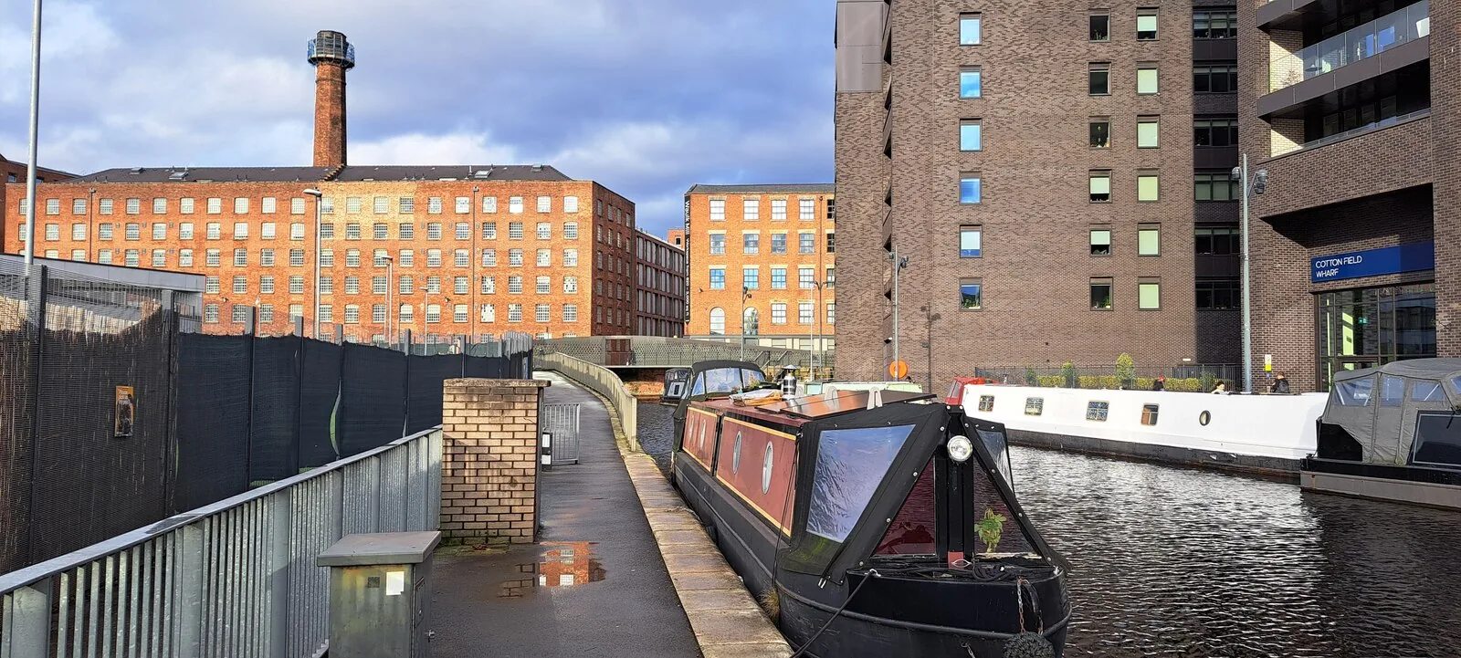 Narrowboats, greenery and waterside architecture at New Islington Marina, Manchester